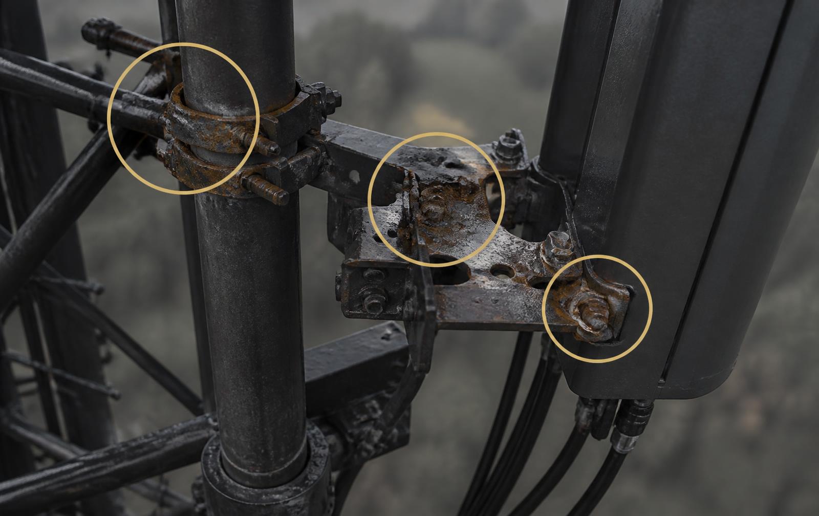 Drone inspection image of a tower antenna mount with defect markers highlighting corrosion